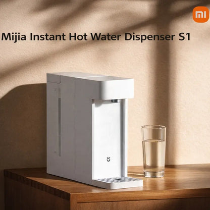 instant hot water dispenser on a modern home office desk next to a laptop and mug.